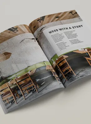 Open magazine displaying an article titled 'Wood with a Story' with images of wooden chairs and table in a rustic setting.