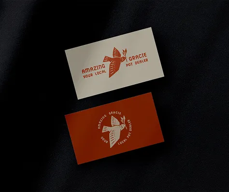 Two business cards with a bird logo and text 'Amazing Gracie Your Local Pot Dealer' on black background, one card beige and the other dark red.