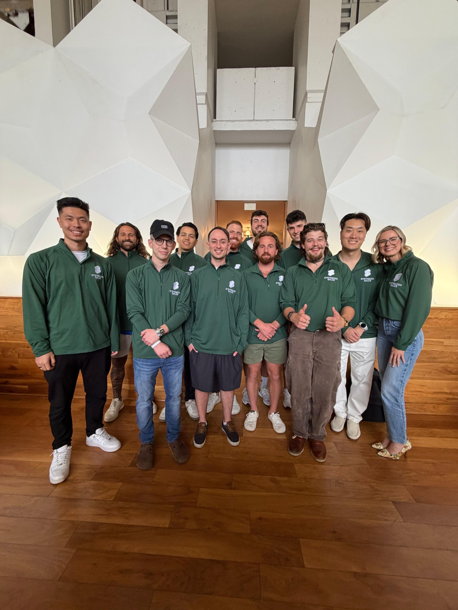 Systemized Sales team together in matching green shirts