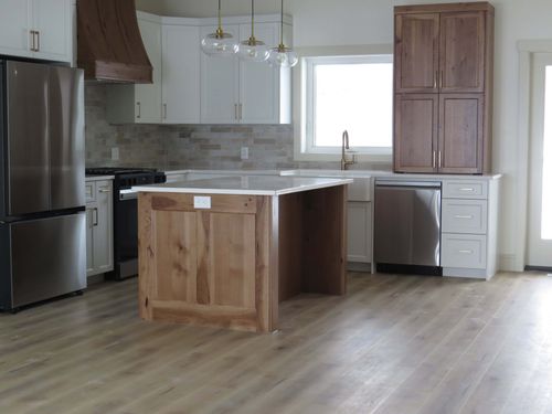 dark wooded finished kitchen with white countertops