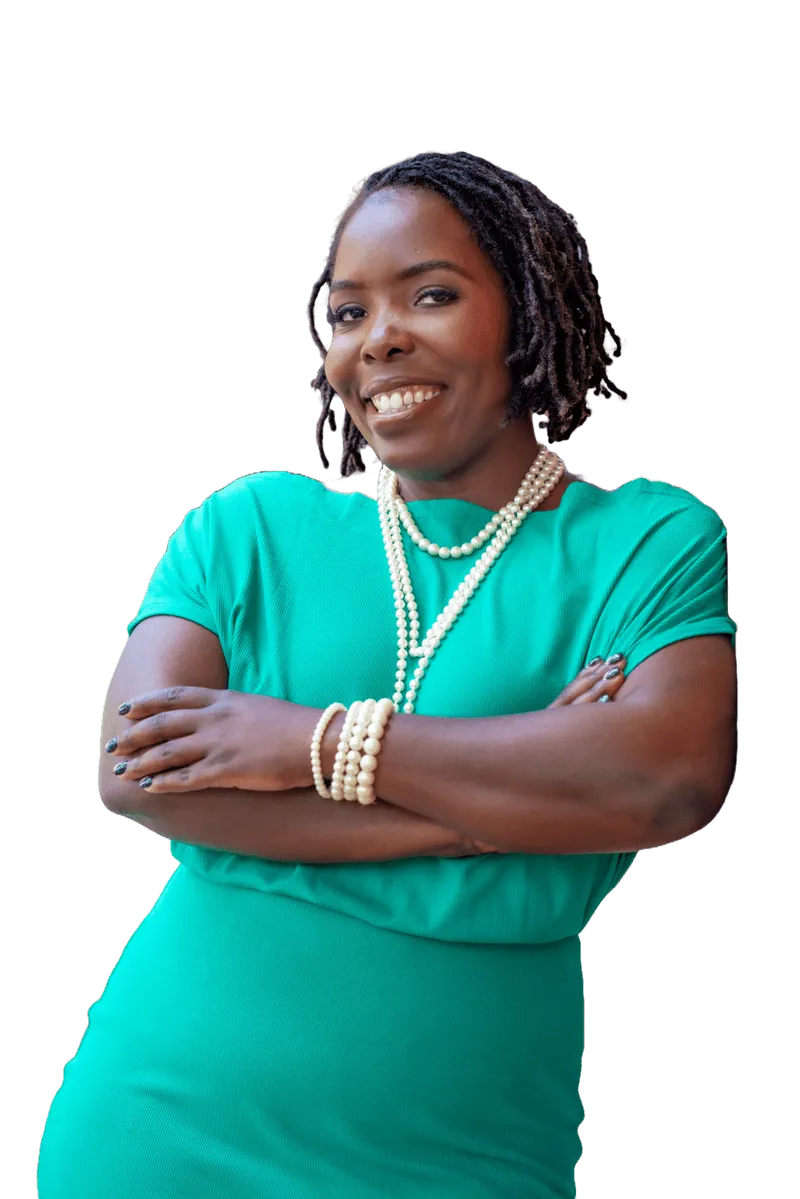 A woman in a green dress with her arms crossed