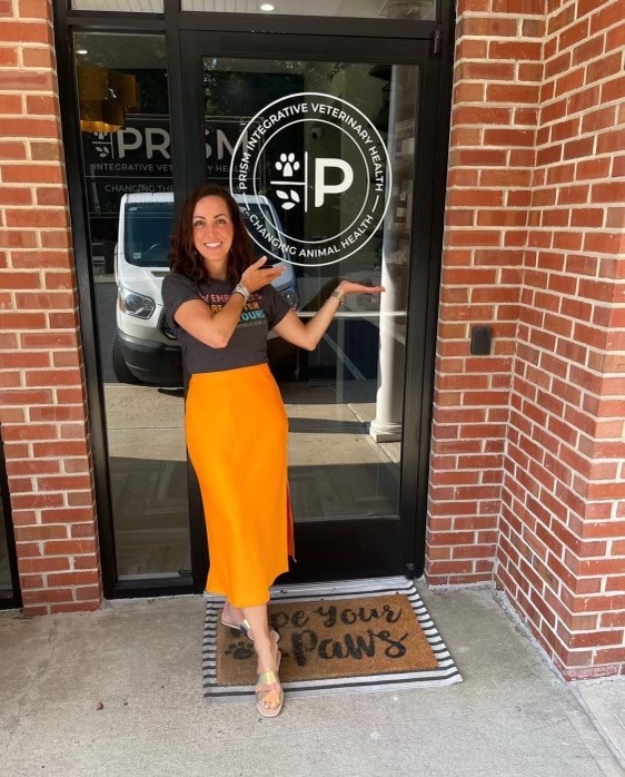Dr. Kendra Pope standing at the entrance of Prism Integrative Veterinary Health, a leading provider of Medical Ozone therapy for pets in New Jersey.