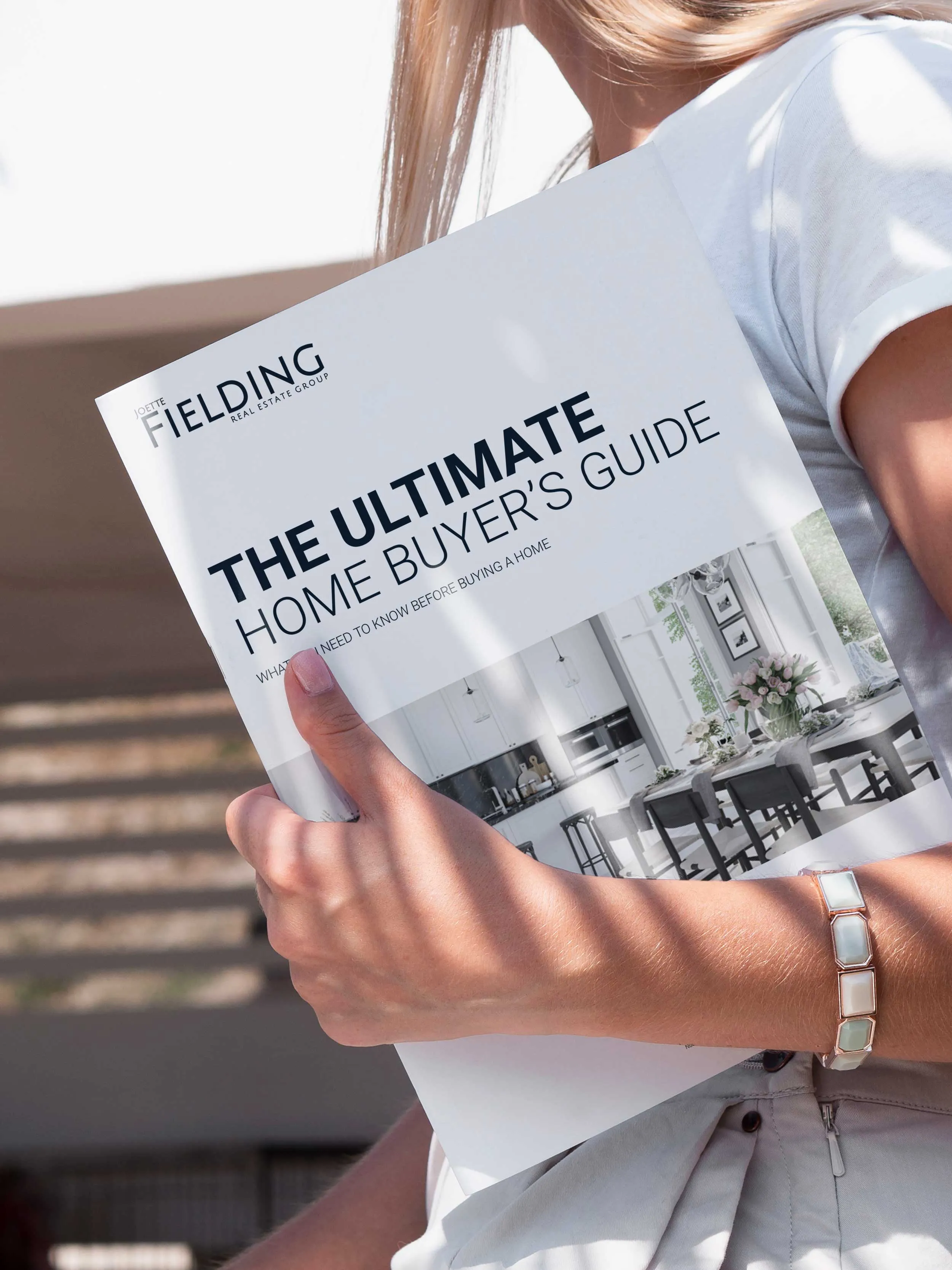 Caucasian women walking with the buyer's guide booklet in her arms.