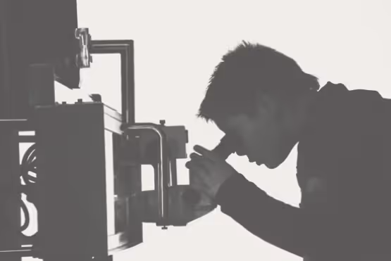 A man looking into a microscope
