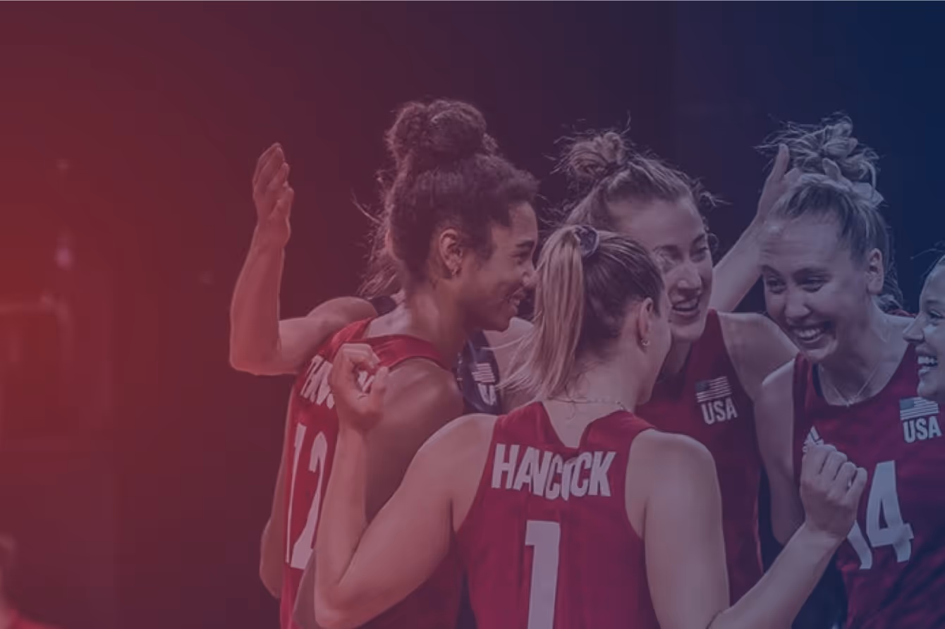 Smiling volleyball players in a huddle
