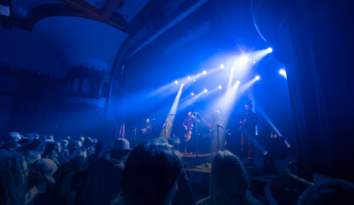 A band performing on stage at the Wheeler Opera House