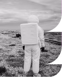 A black and white photo of an astronot in a field cropped into an E shape.