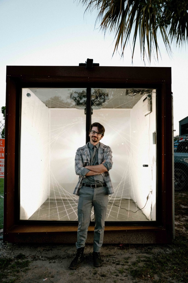 Angel in front of his interactive installation, informed by his work as a digital designer