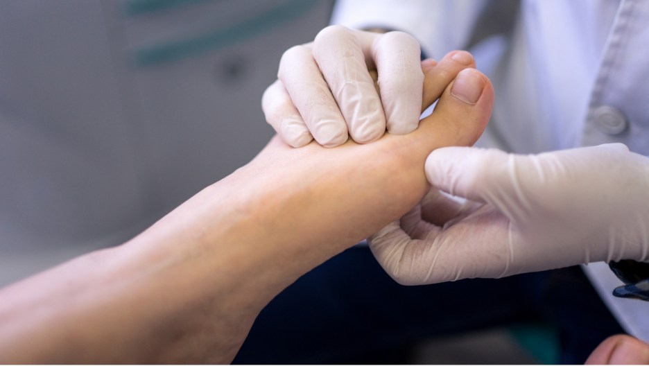 A person's hand holding a person's footAI-generated content may be incorrect.