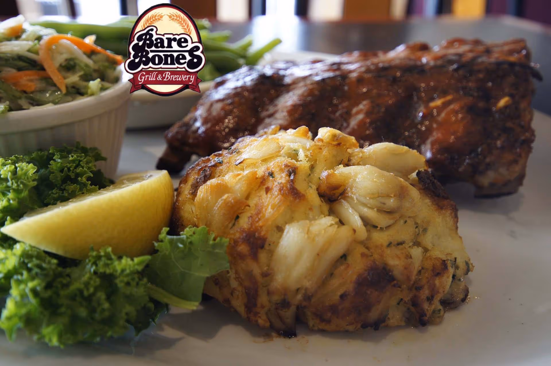 A plate of food with a lemon wedge and a grilled steak.
