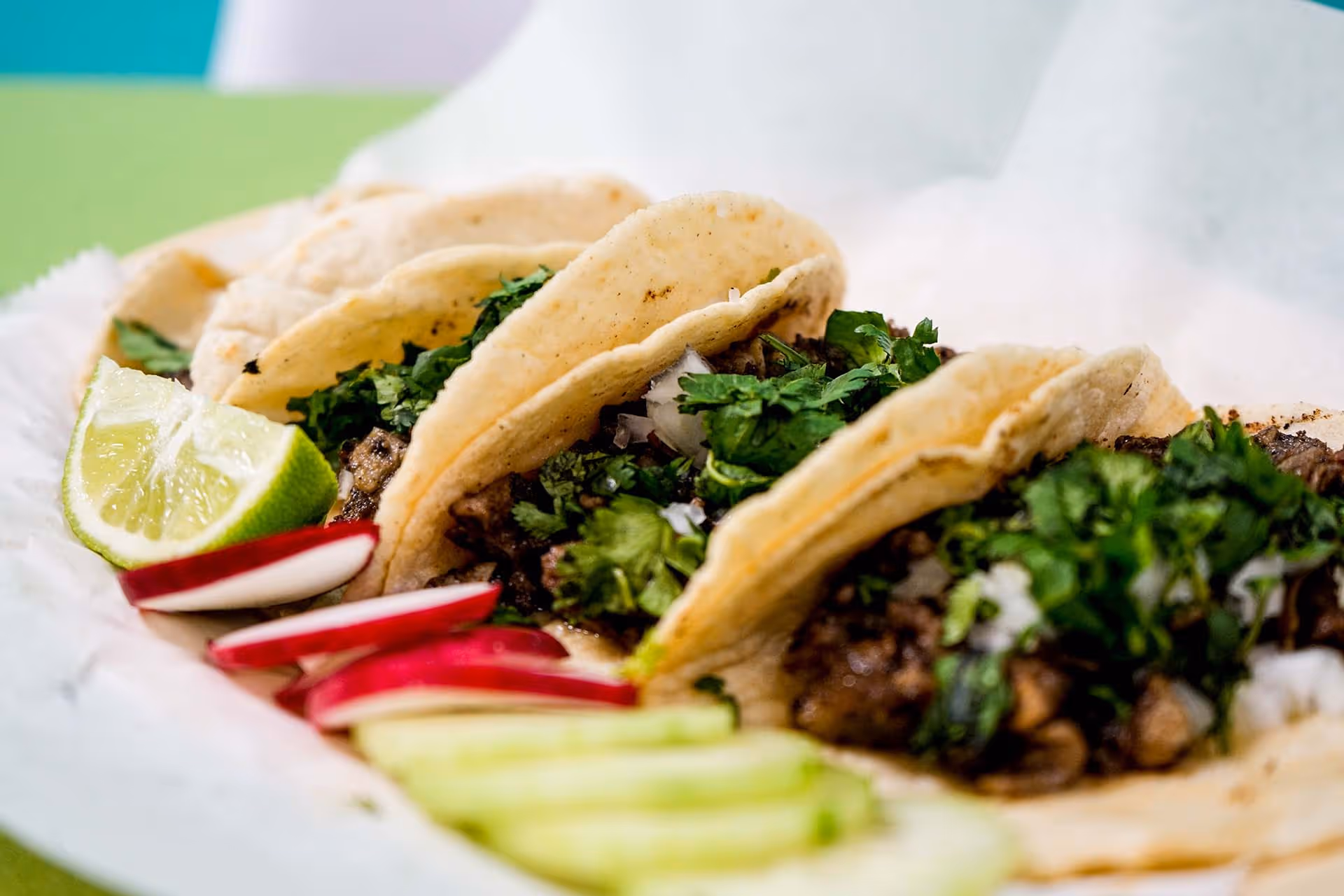 A plate of tacos with lettuce and tomatoes.