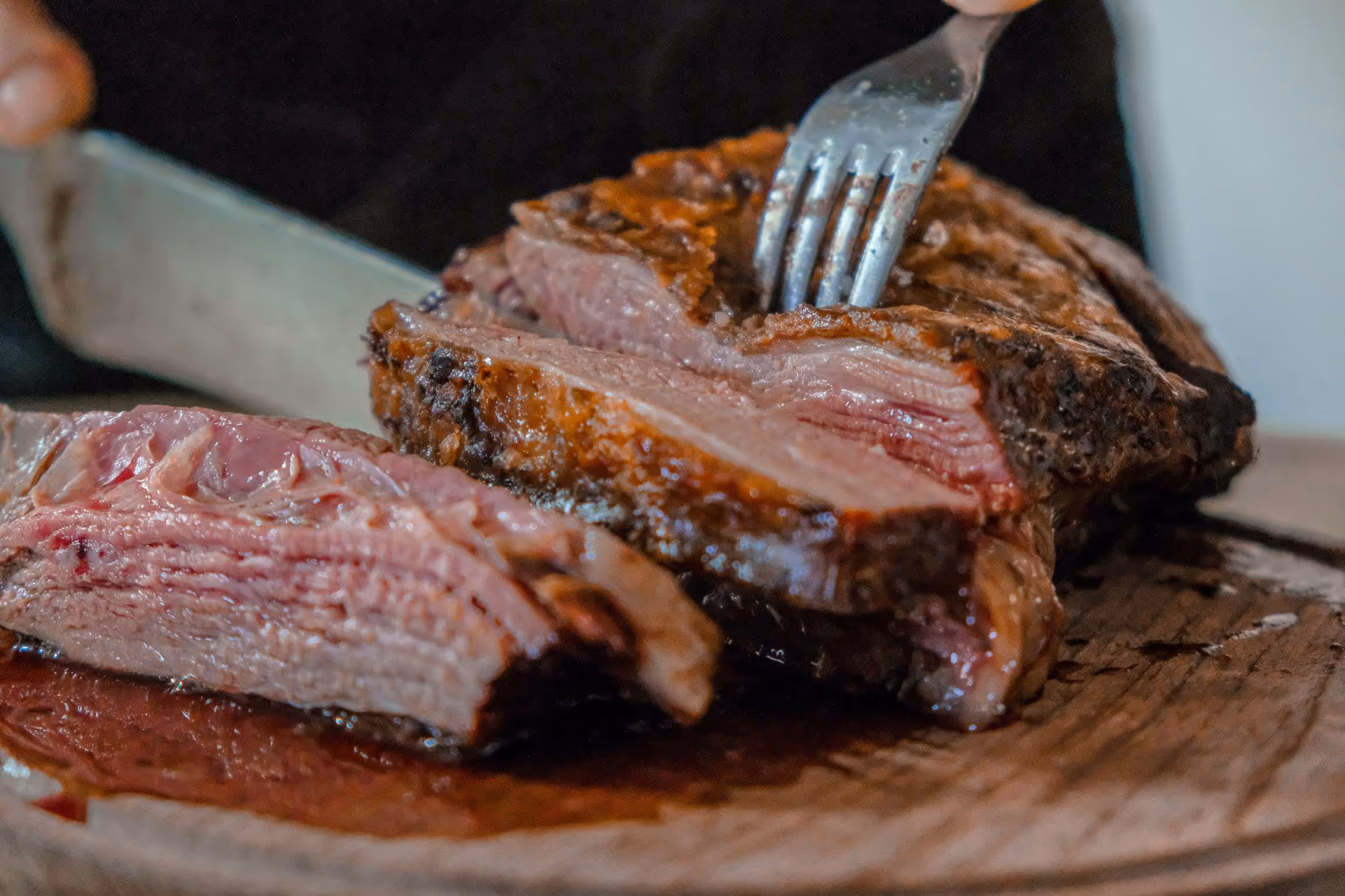 A piece of meat on a wooden cutting board.