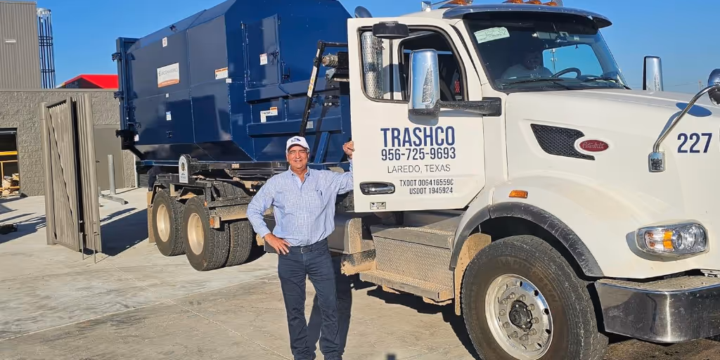 Trashco team in front of a Trashco truck