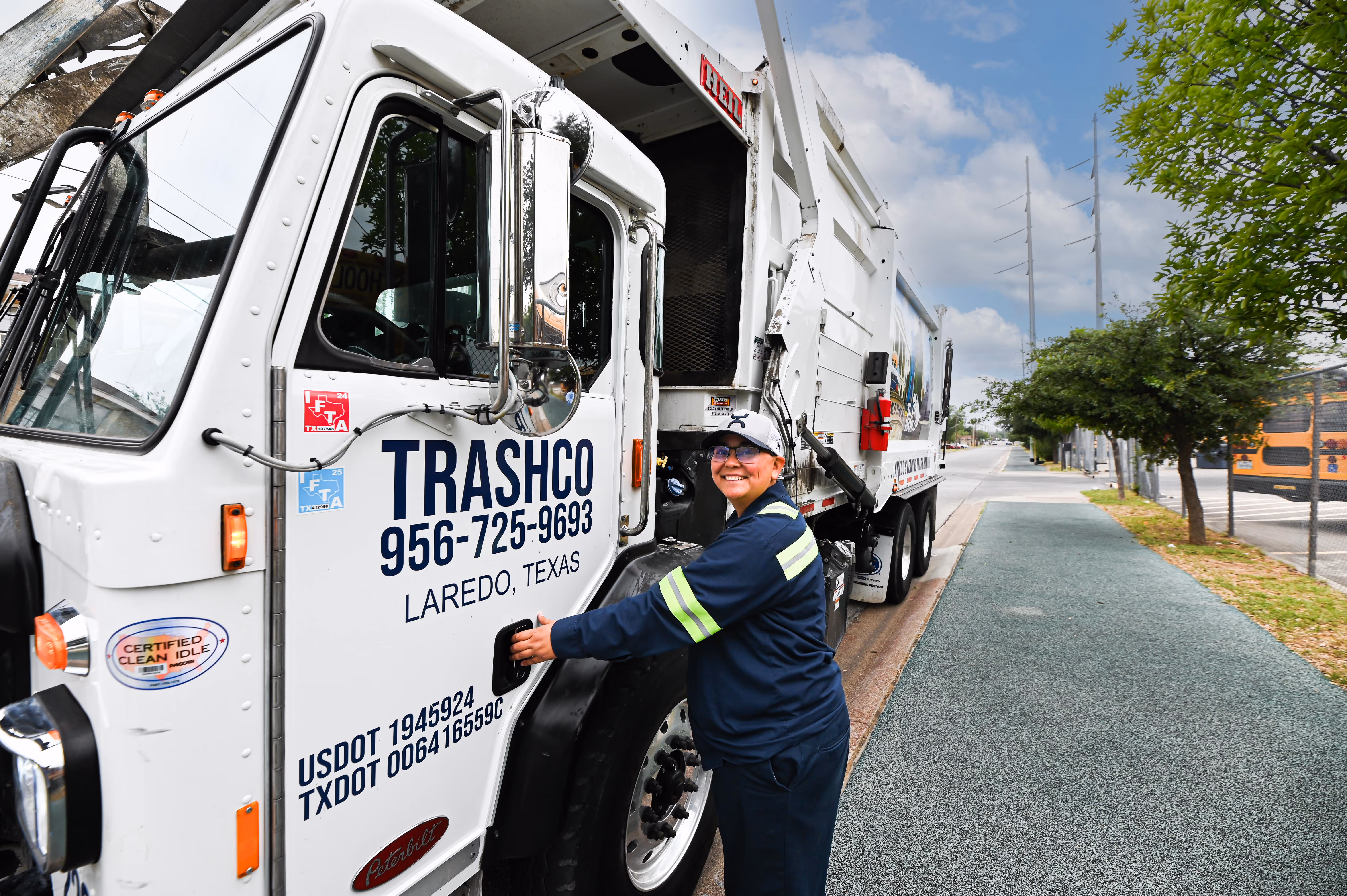 Woman standing next to a Trashco truck