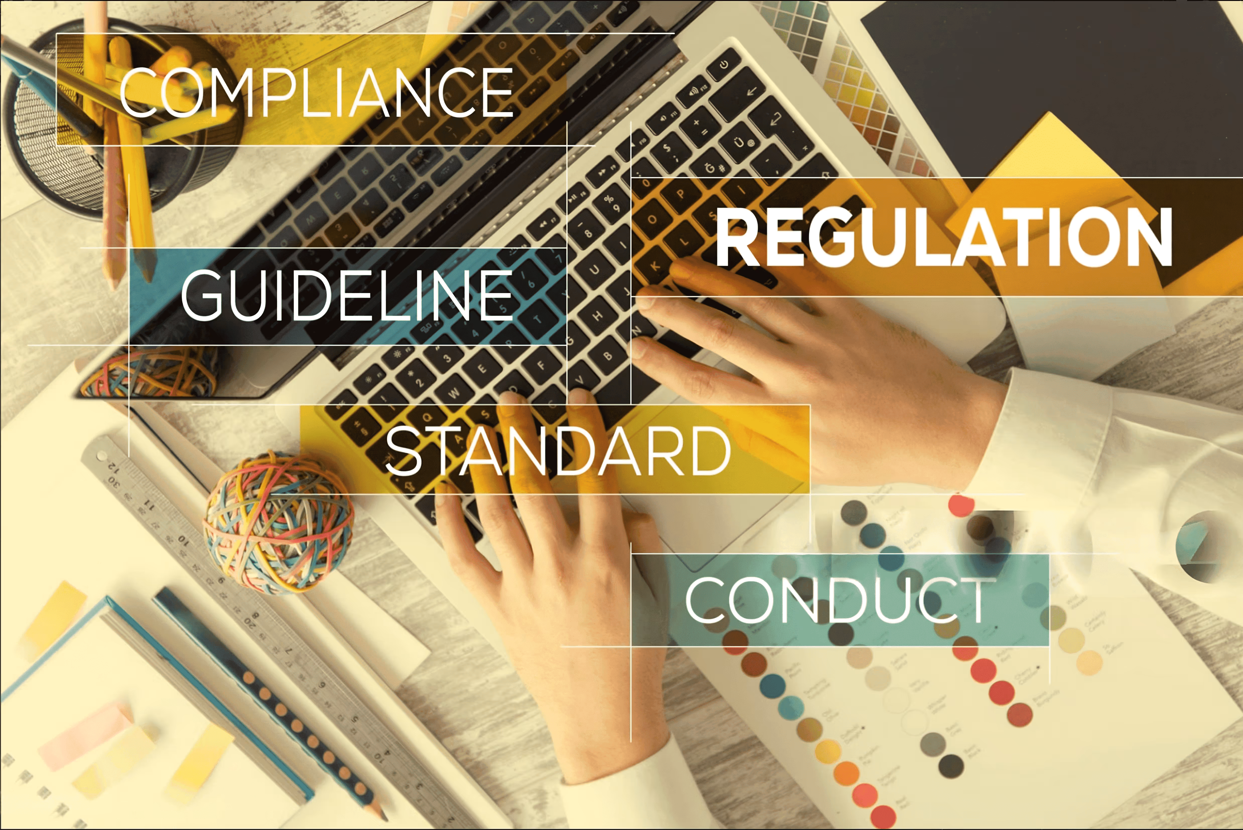 Hands on laptop with compliance keywords.