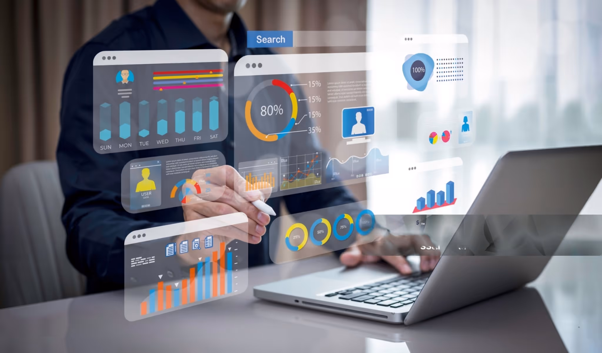 Person working on laptop with virtual data dashboards.
