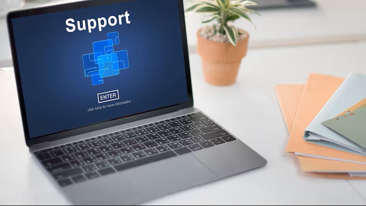 Laptop on desk displaying a screen with the word 'Support' and a blue graphic with an 'ENTER' button below it.