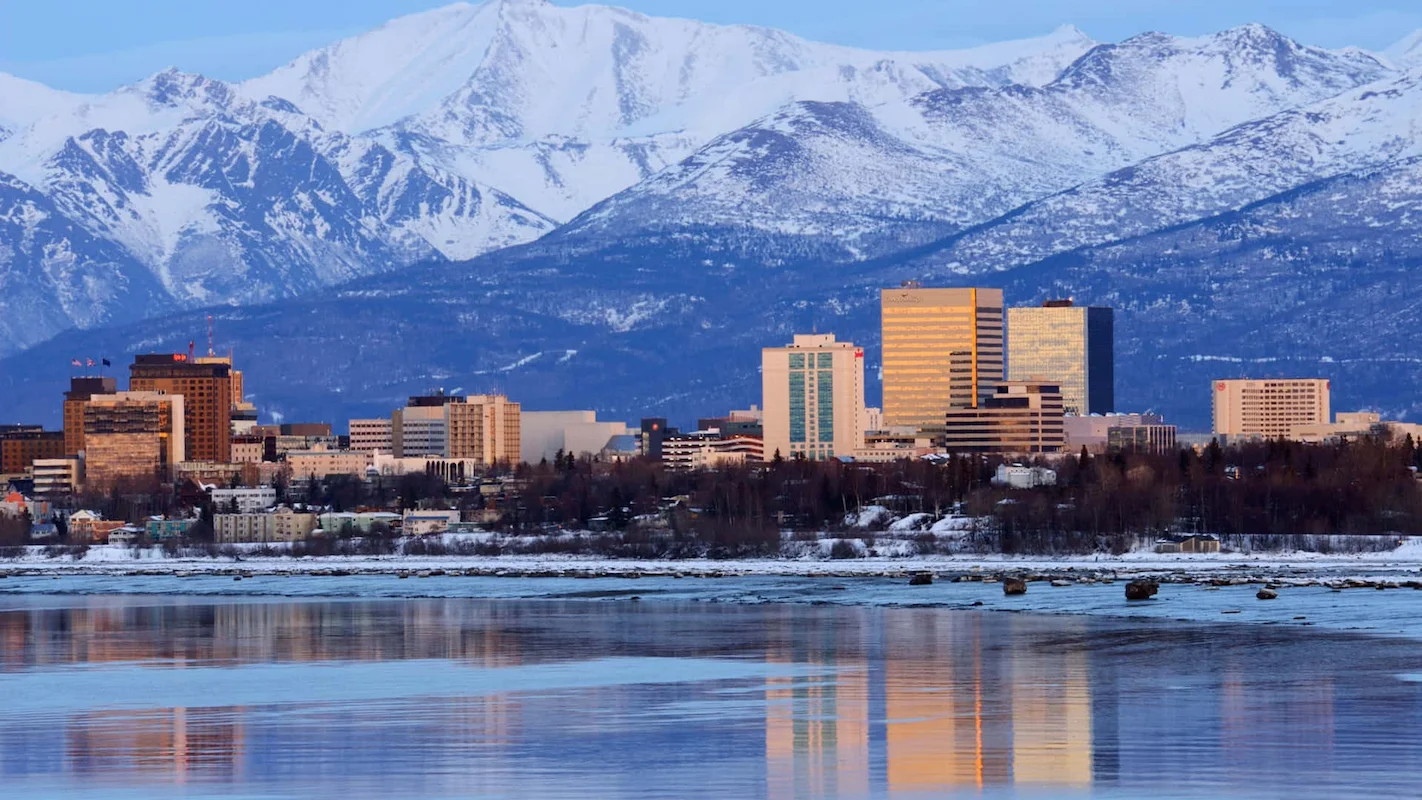 Photo of the Anchorage, Alaska, skyline with snow-capped mountains, representing a key US market for homeowners looking to sell their house and access home equity