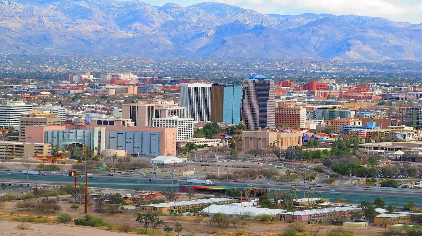 Photo of a city skyline in Arizona (e.g., Tucson) with mountains in the background, representing a key US market for homeowners looking to sell their house and access home equity