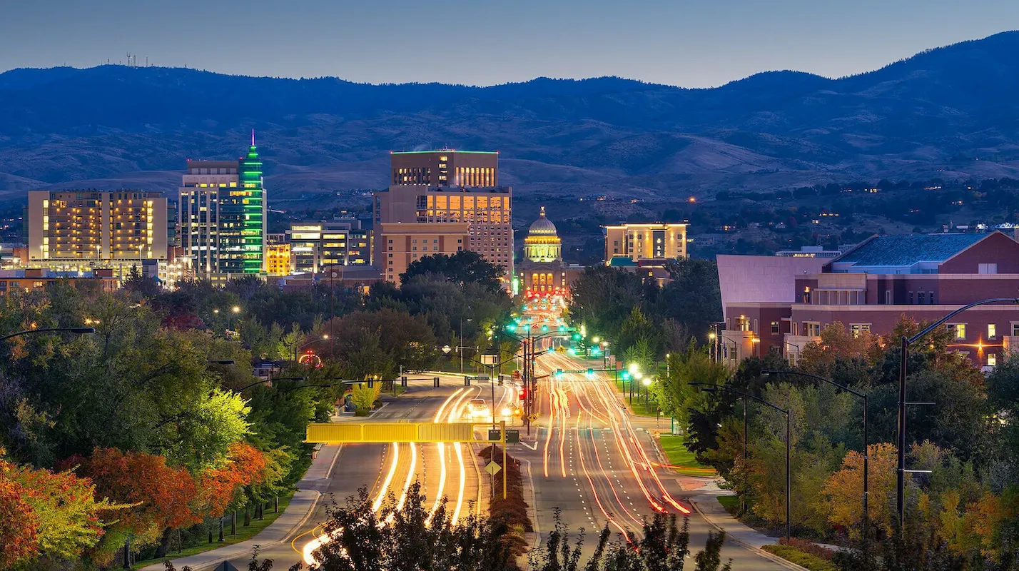 Photo of the Boise, Idaho, city skyline at dusk with mountains, representing a key US market for homeowners to sell their house and access home equity
