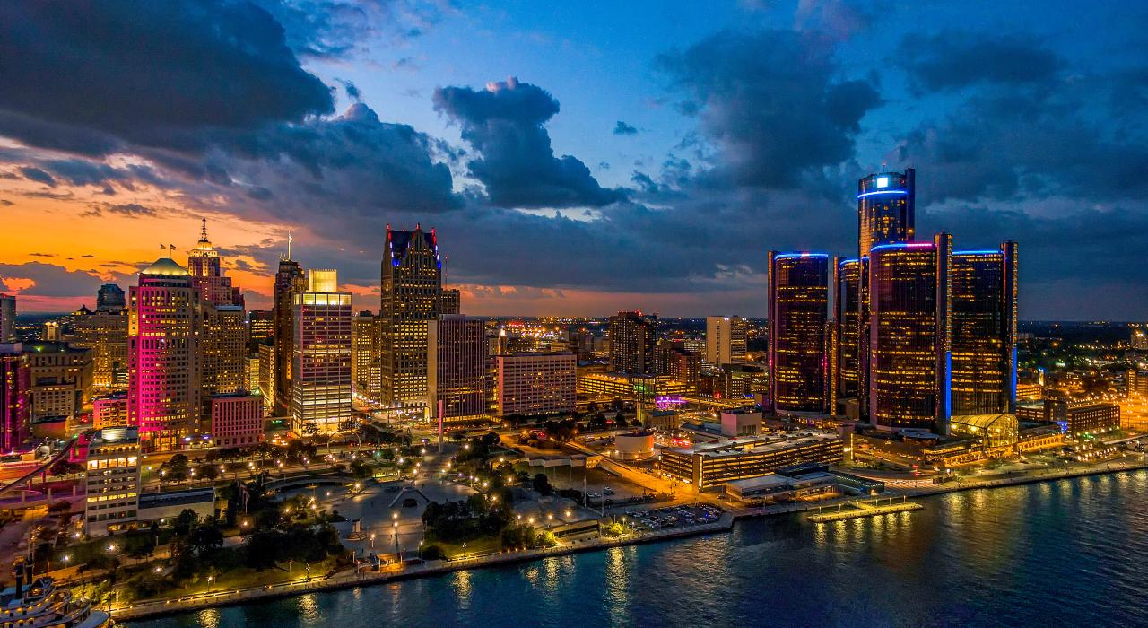 Night photo of the Detroit, Michigan, city skyline along the water, representing a key US market for homeowners to sell their house and access home equity