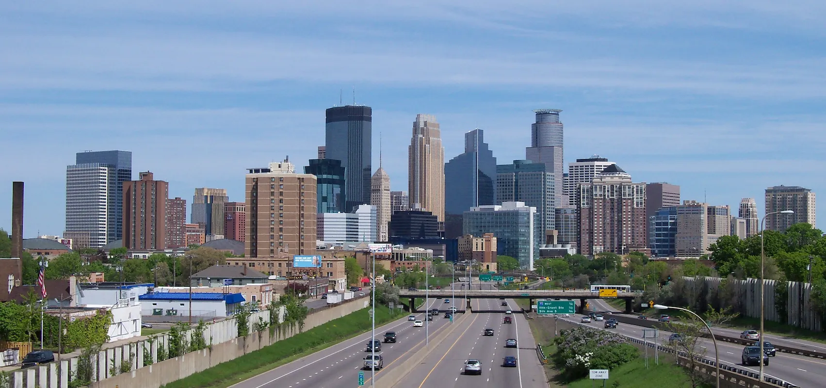 Photo of the Minneapolis, Minnesota, city skyline with a major highway, representing a key US market for homeowners to sell their house and access home equity
