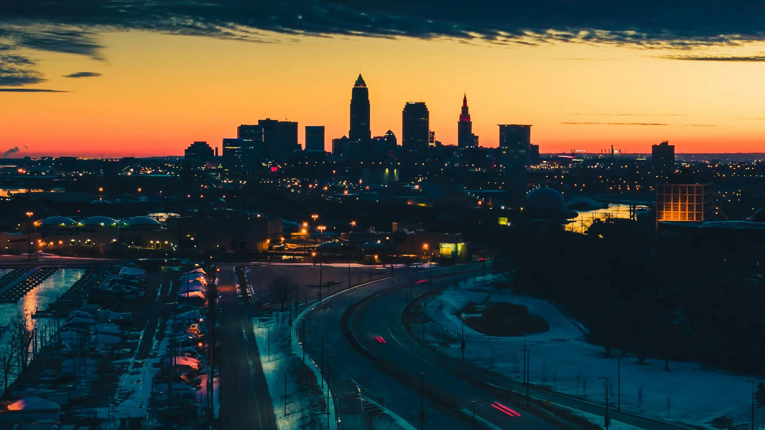 Photo of a major Ohio city skyline (e.g., Cleveland) at sunset, representing a key US market for homeowners to sell their house and access home equity