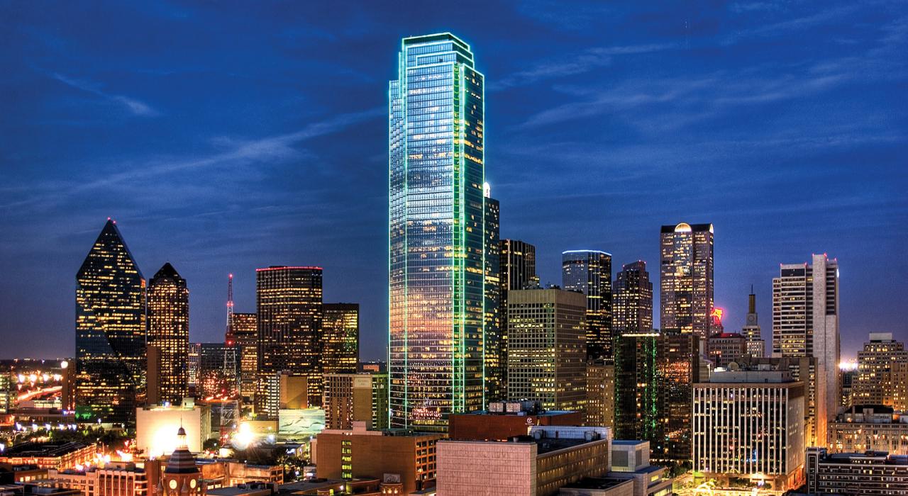 Photo of the illuminated Dallas, Texas, city skyline at night, representing a key, fast-moving US market for homeowners to sell their house and access home equity