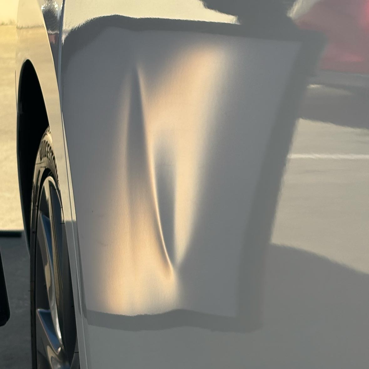 Mazda 3 driver's side rear door dent before paintless dent repair