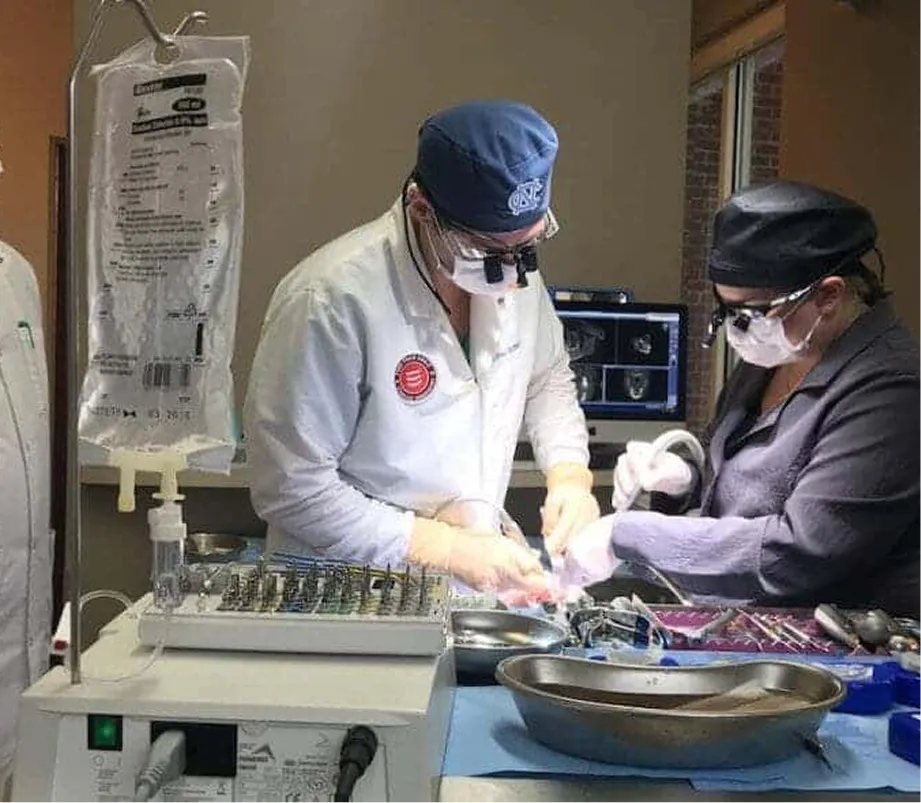 Medical professionals performing surgery with surgical instruments and equipment