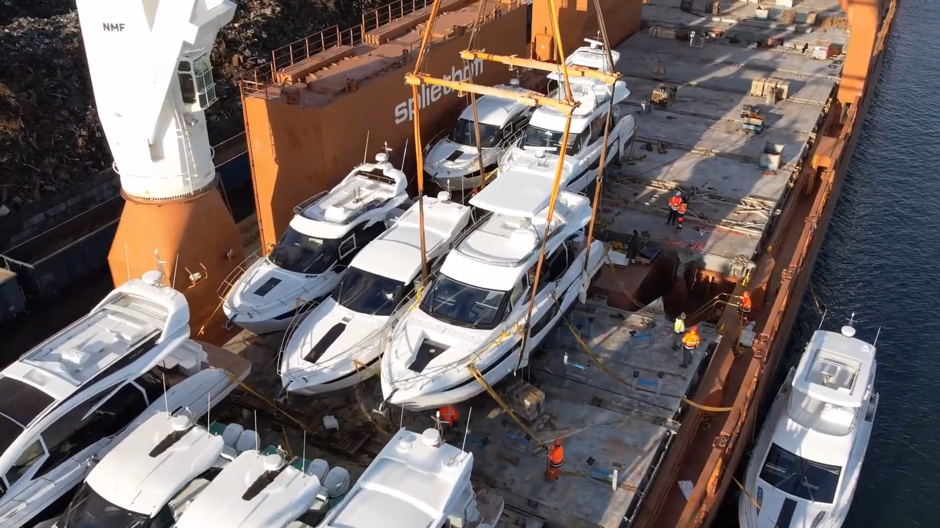 Row of Galeon hulls chocked on a cargo ship deck, photographed from overhead.