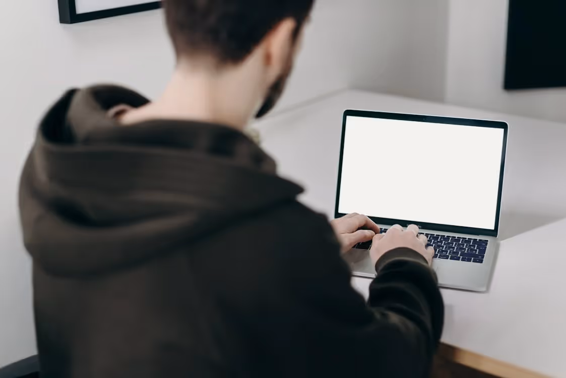 a person sitting at a blank computer