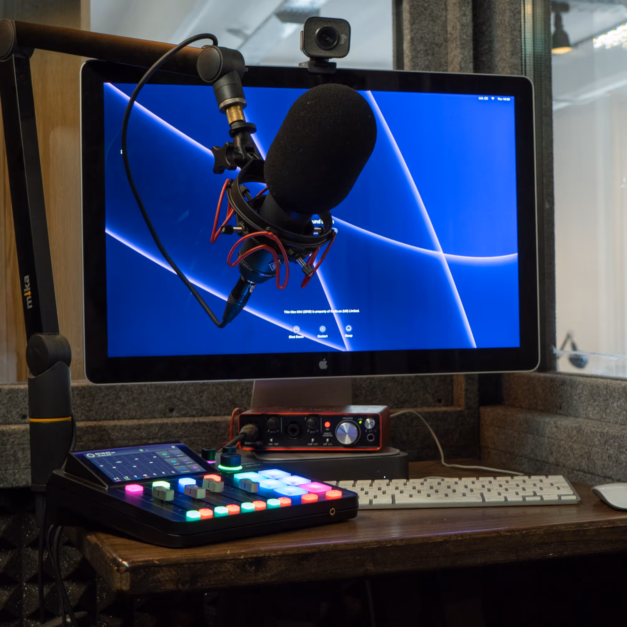 A computer with a microphone and mixer.