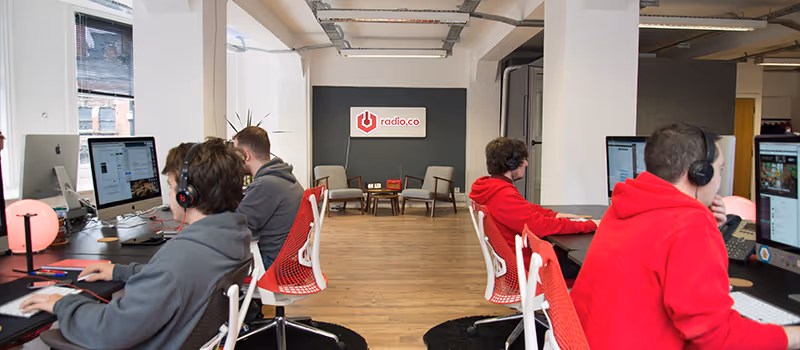 The Radio.co team working in the office.
