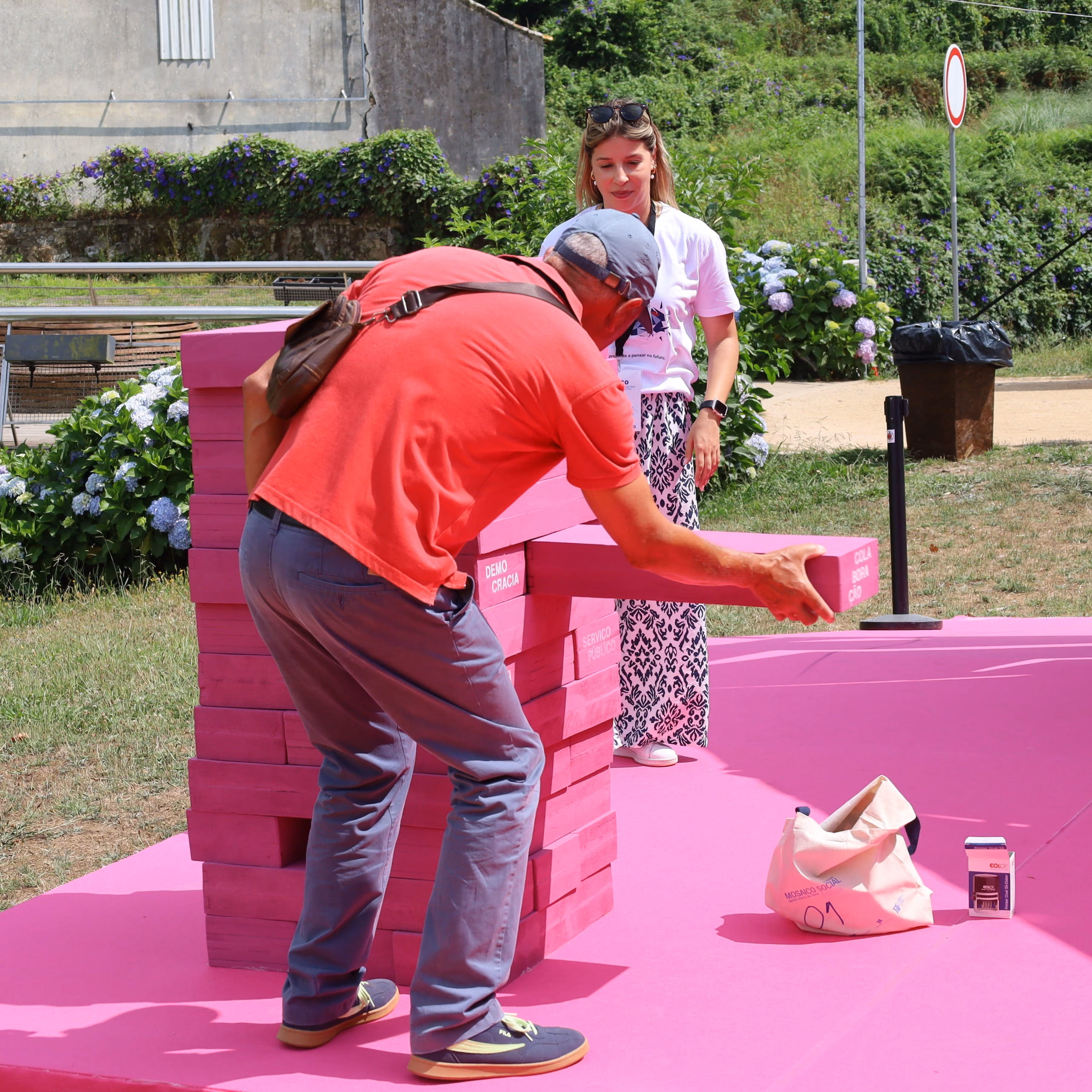 Participante do Mosaico Social a jogar o Jenga social.