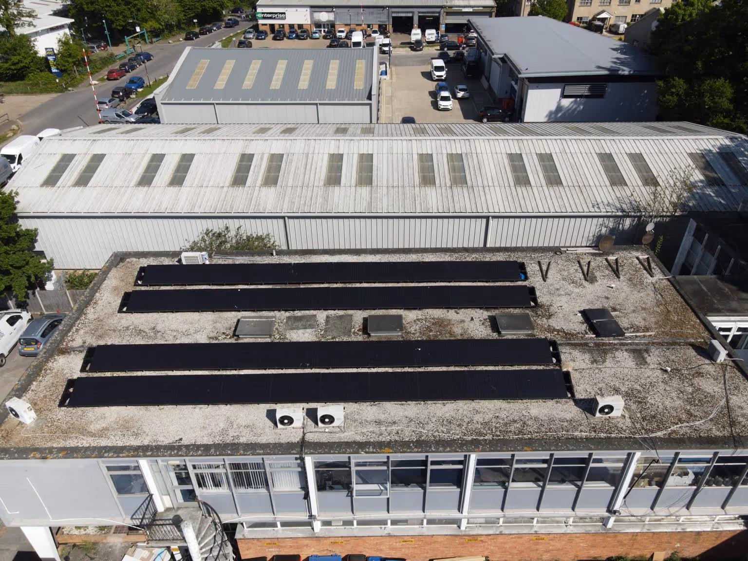 A rooftop of a building with solar panelsAI-generated content may be incorrect.