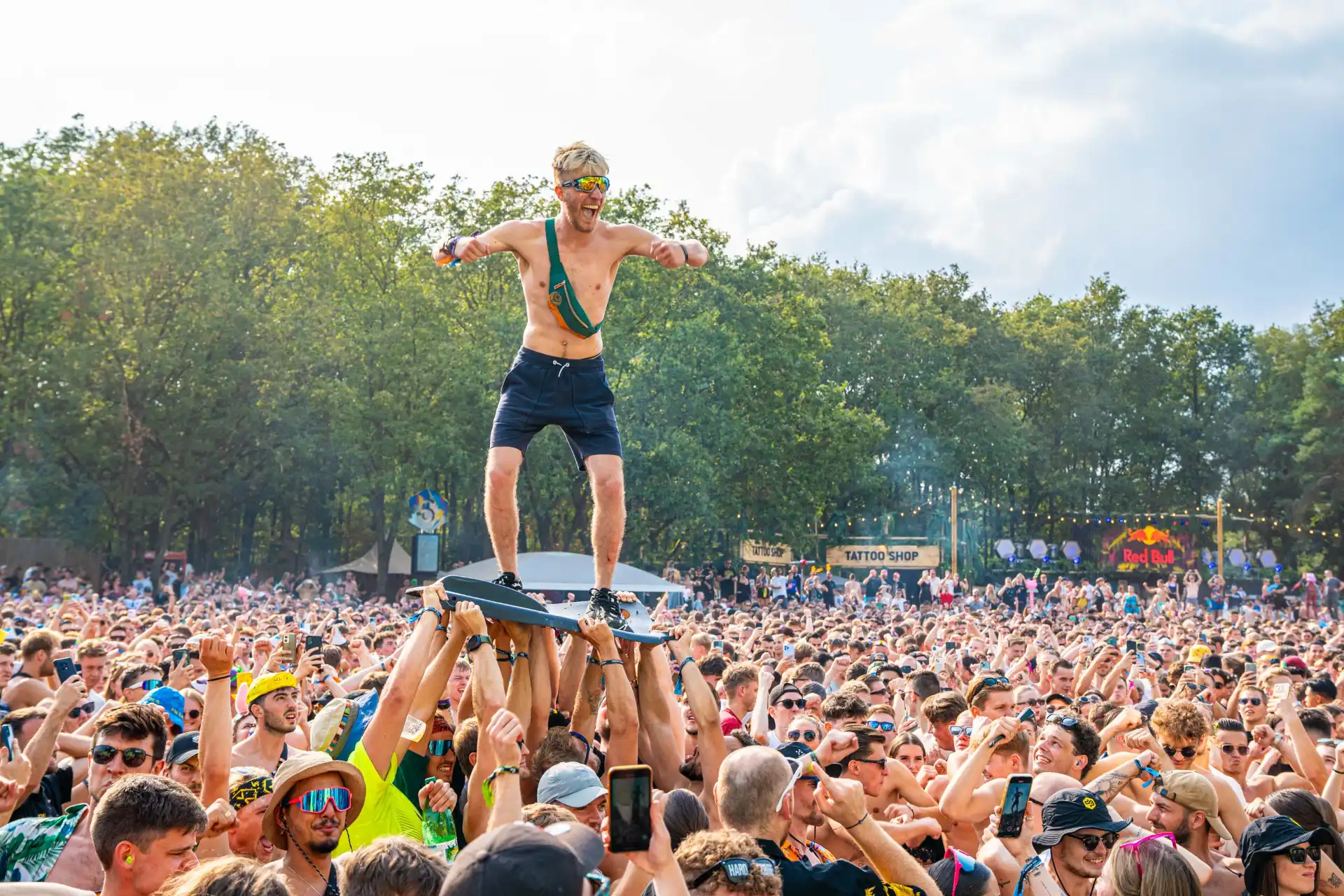 Decibel Outdoor festival crowd cheering, person standing on hands of audience