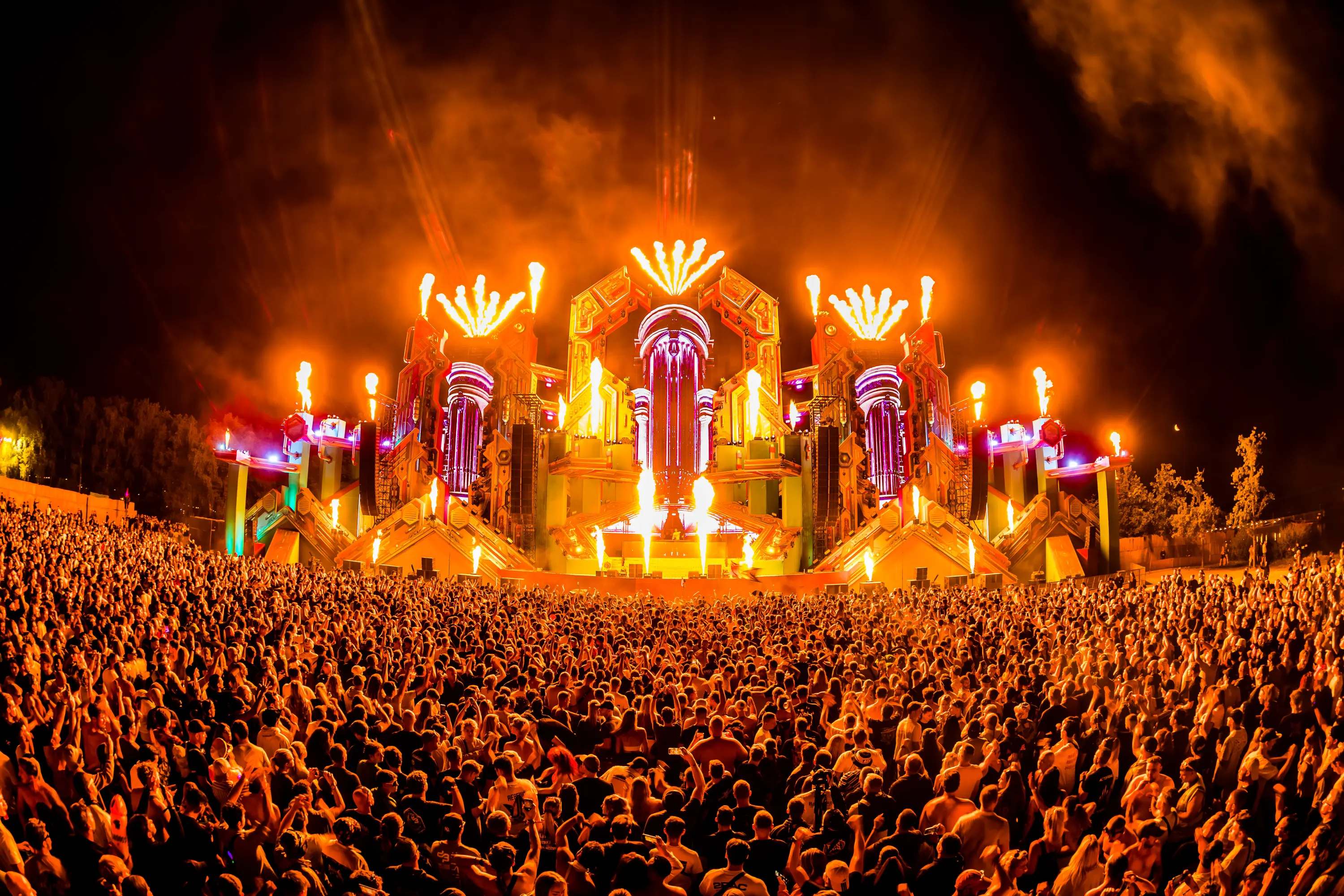 Decibel Outdoor festival with vibrant stage and excited crowd under blue sky
