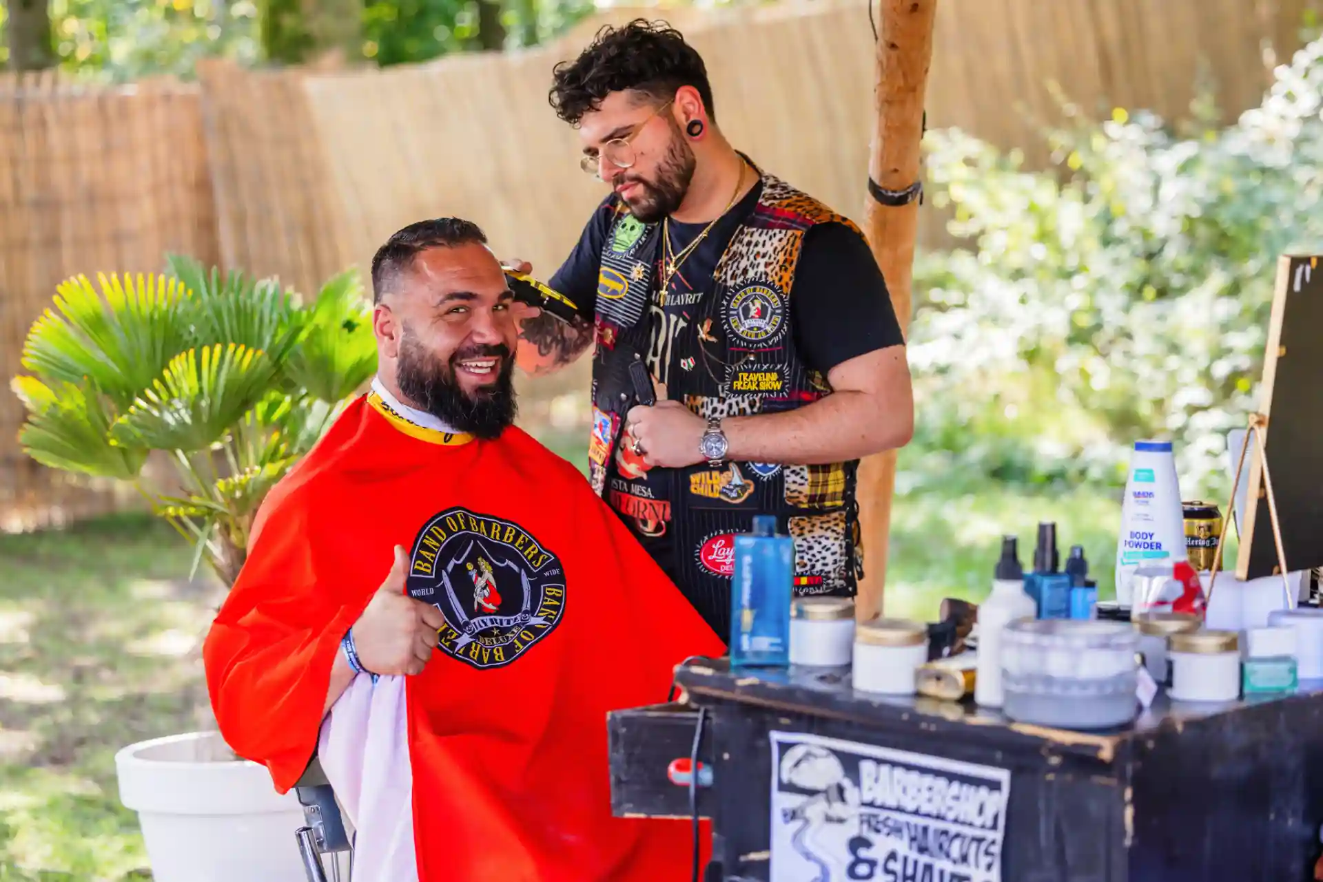 Decibel Outdoor barber shop with stylists cutting hair in backyard setting