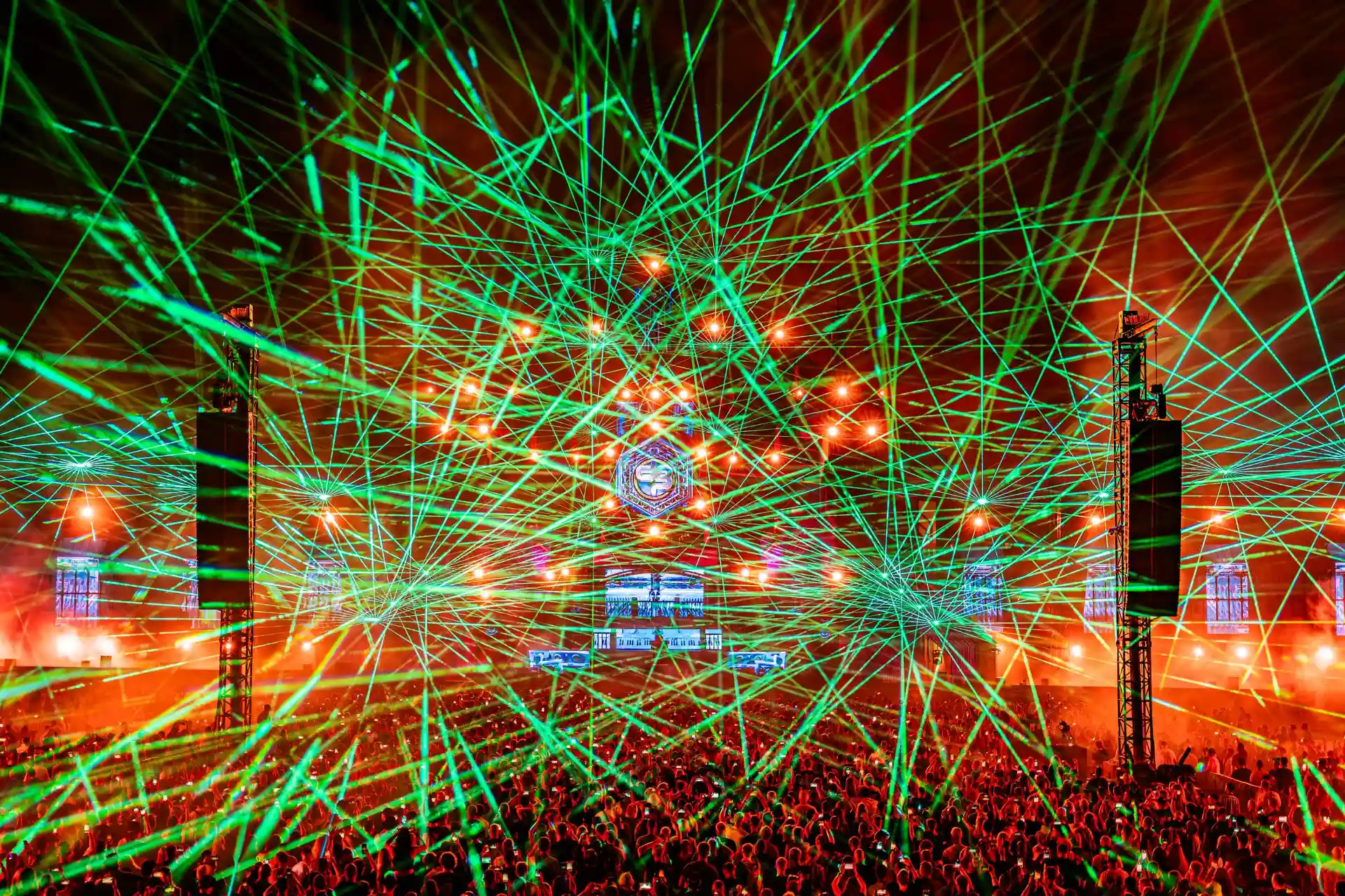Decibel Outdoor festival with intense green laser light show over crowded concert