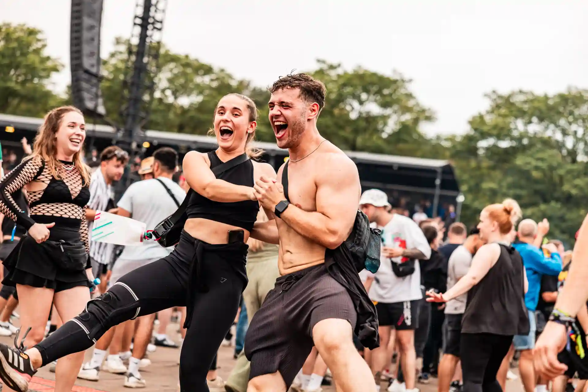 Decibel Outdoor festival attendees joyfully dancing and celebrating together