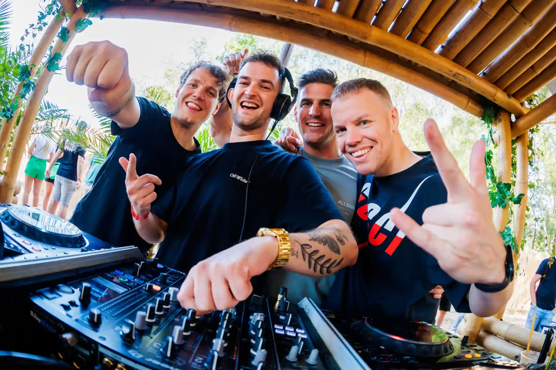 Decibel Outdoor: DJs smiling and performing at tropical outdoor music event
