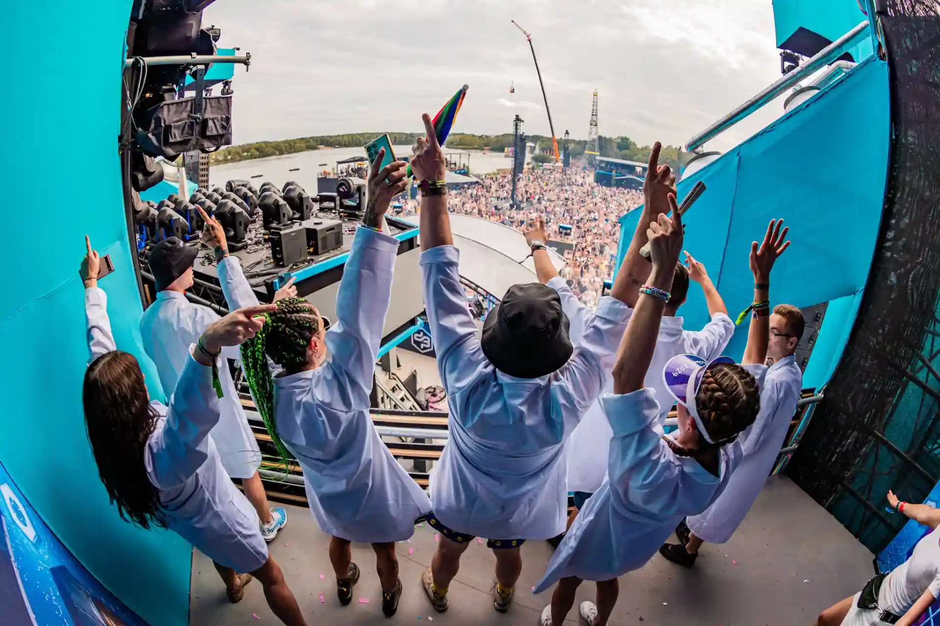 Decibel Outdoor Festival: Crew raising hands on stage overlooking massive crowd