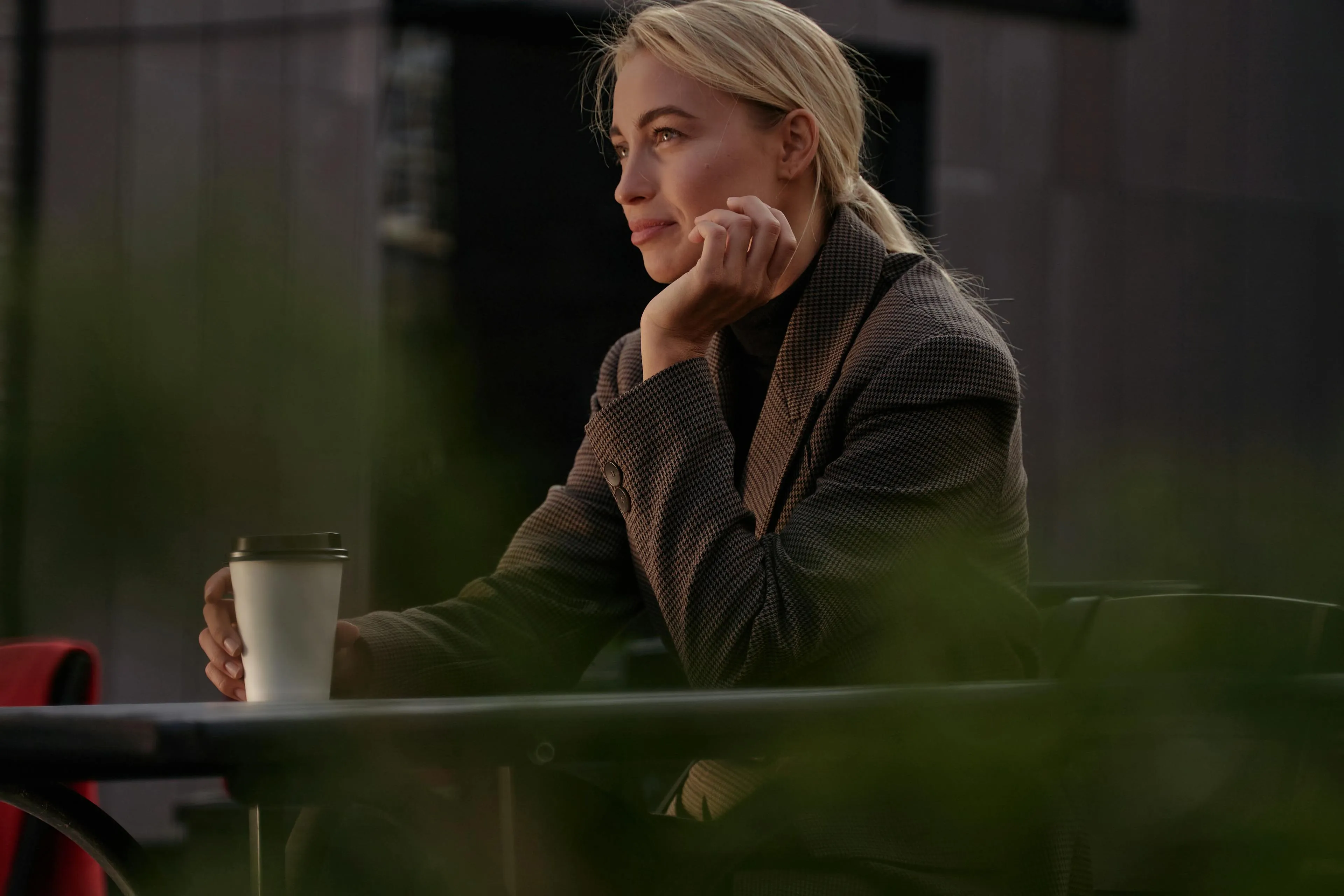 blonde woman sitting with cofffee