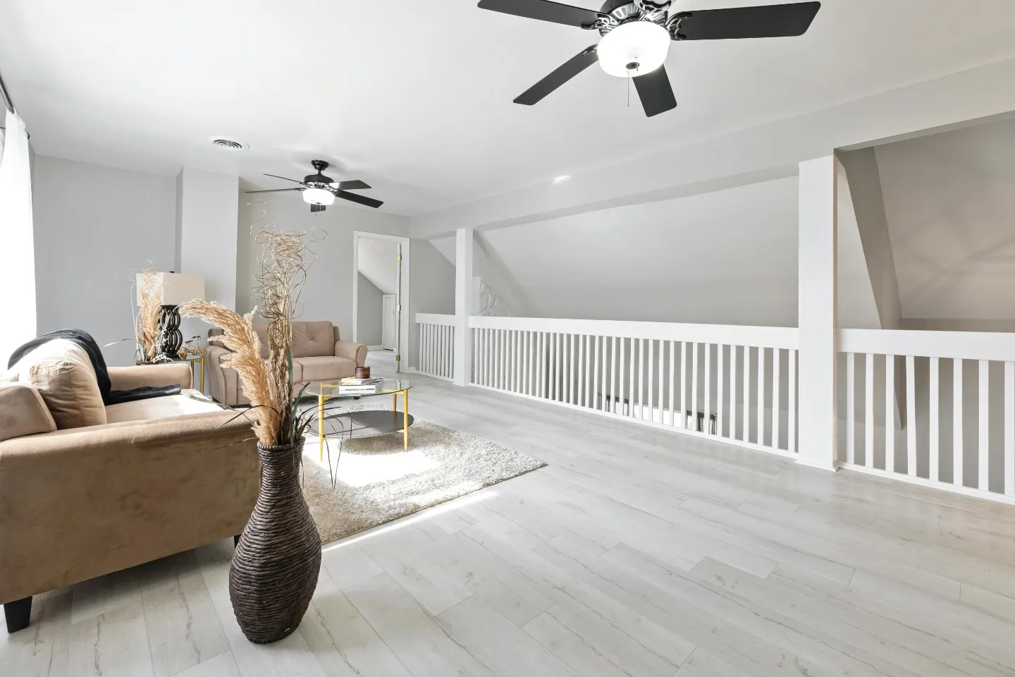 loft with ceiling fans