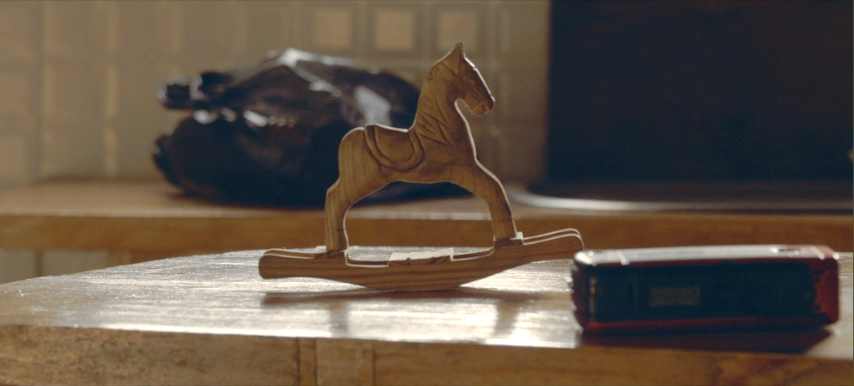 A wooden rocking horse toy.