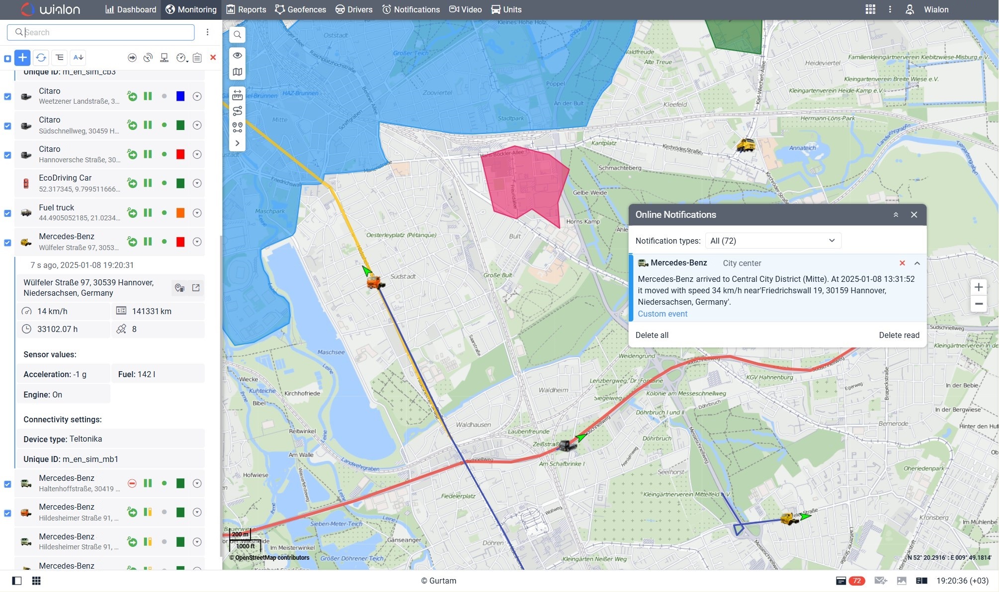Wialon fleet tracking dashboard showing a city map with vehicle routes, geofenced areas in blue and red, vehicle icons with status indicators, and an online notification about a Mercedes-Benz arriving at Central City District, Hannover, Germany.