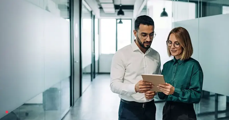 Business colleagues reviewing a tablet in a modern Danish office