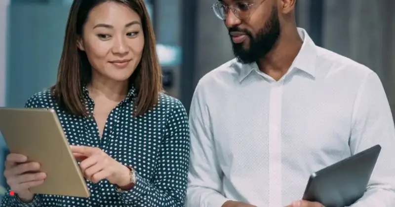 Two business professionals comparing Danish employment options