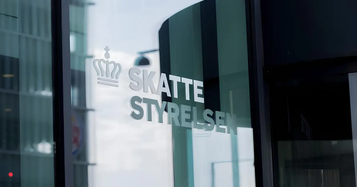 Skattestyrelsen signage on the glass entrance of a Danish Tax Agency office.